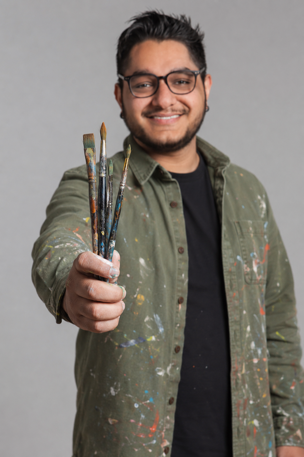 Founder Zubair Parkar holding paint brushes